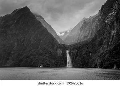 Waterfall at Milford Sound Fjord in rainy weather and dramatic sky - South Island of New Zealand - black and white photography. This fiord is considered as one of the most scenic places in the world. - Powered by Shutterstock