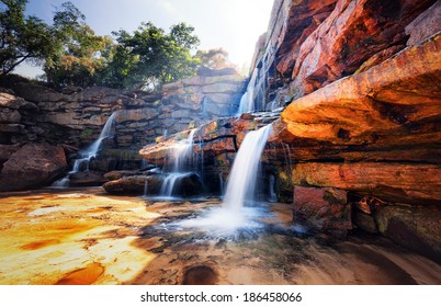 Waterfall and mountain landscape. Fresh water river stream flowing through beautiful rocky canyon. Nature photography 