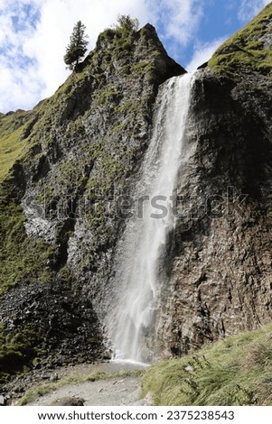 A waterfall in the mountains, Veil Waterfall, Hintertux