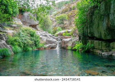 waterfall and natural pool in the uninhabited village of Drave, the most isolated village in Portugal.