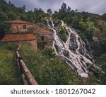 A waterfall next to a mill