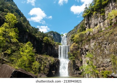 A waterfall on a cliff in the mountains