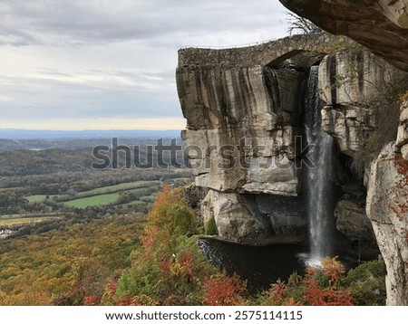 Waterfall on Cliff Overlooking Fall Foliage