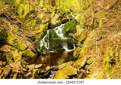 Waterfall on mossy rocks view. Waterfall cascade on rocks. Forest waterfall cascade on rocks. Waterfall cascade in forest