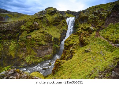 A waterfall on a narrow gorge in the beautiful volcanic landscape of the trek from Skógafoss up to the Fimmvörðuháls hut and pass, south Iceland
