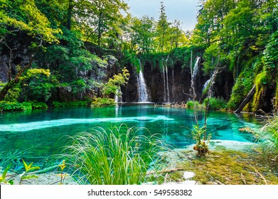 Waterfall over the turquoise waters of the lake.