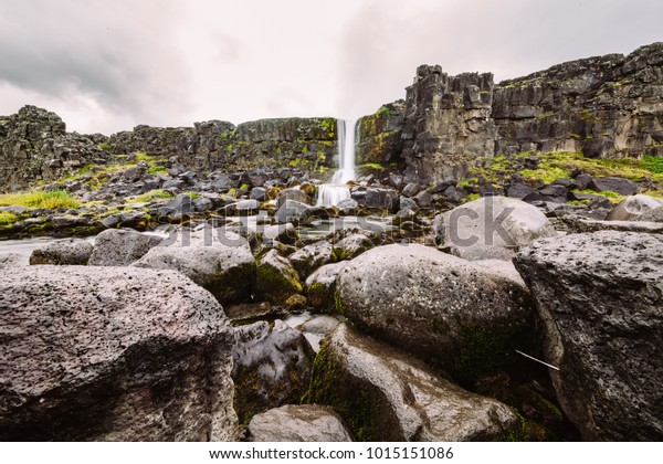 Waterfall at Pingvellir, the continental divide\
in Iceland between The Eurasian Continent and The North American\
Continent.Oxararfoss waterfall, Thingvellir National Park,\
Iceland.Long exposure