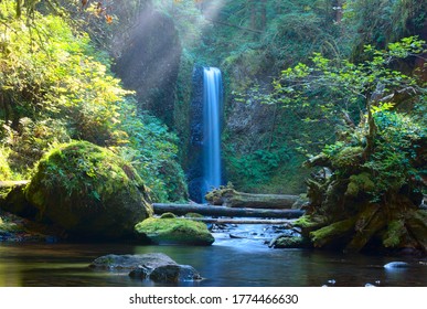 Waterfall with rays of sunlight.