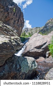 Waterfall Spills Over Boulders In Rocky Mountain National Park  On Emerald Lake Trail Near Estes Park Colorado On Sunny Summer Day