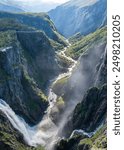 Waterfall in a steep ravine with greenery