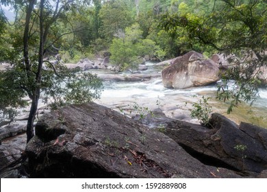 Waterfall with a strong flood of water rocks below.Crystal clear water, huge stones with a beautiful vegetation around. At the end forming a strong current and later a calm lake with clean transparent
