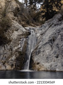 Waterfall Through Rocks Into Swimming Hole