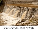 Waterfall and torrential downpour after heavy rain in the Romanian mountains