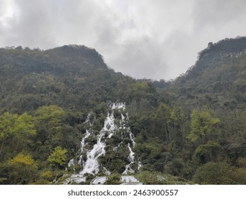 Waterfall under the cloudy sky