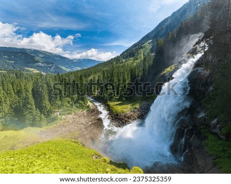 Waterfall view in the forest.  The Waterfall is hidden in the tropical jungle. Waterfall streams in the green mossy mountain. beautiful waterfall.