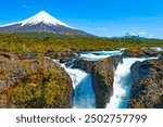 Petrohué Waterfalls (Saltos del Petrohué) in the Vicente Pérez Rosales National Park, with Osorno volcano in the background. Chile.