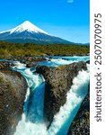 Petrohué Waterfalls (Saltos del Petrohué) in the Vicente Pérez Rosales National Park, with Osorno volcano in the background.