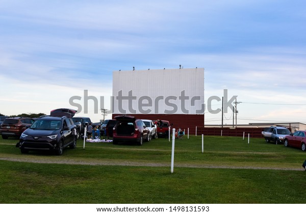 Waterford, PA / United States - September 2019 :
Sunset Drive In Movie theater with cars outdoor movie screen blue
sky green grass