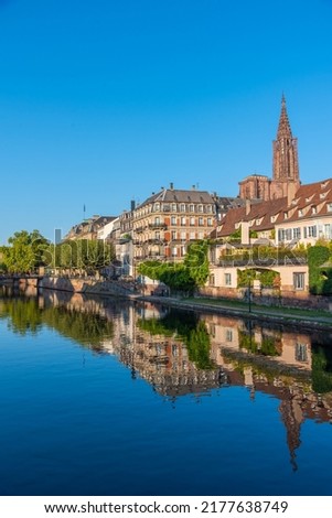 Waterfront of a channel passing the old town of Strasbourg and cathedral of our lady, France