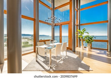waterfront condominium dining room with floor to ceiling windows 