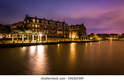 Waterfront condominiums and promenade along the Potomac River at night in Alexandria, Virginia.