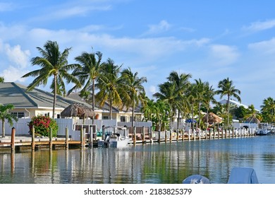 Waterfront homes, palm trees, and boats along the waterway in Marathon key in the Florida Keys	
