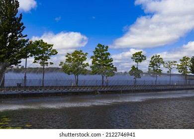 Waterfront Landscaped Park Zone For Walking Aesthetic Outdoor Space With Alley Way Along Fountains Water Streams, Spring Clear Weather Day Photography  