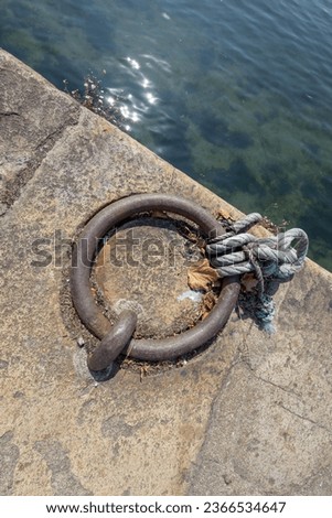 Waterfront mooring handle, iron ring, rust, leaf,+ in the Portuguese city of Porto