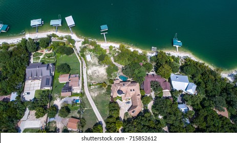 Waterfront Property Aerial drone looking down on homes and houses in community around Lake Travis near outside Austin , Texas right on the water of the Colorado River or Lake Travis on the water docks