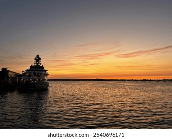 Waterfront Restaurant Silhouette Against Dramatic Harbor Sunset - Powered by Shutterstock