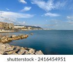 Waterfront in Salerno, Italy. Hills and coastal buildings are visible in the background.