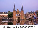 The watergate in the historical city Sneek in Friesland the Netherlands at sunset with the dutch flag