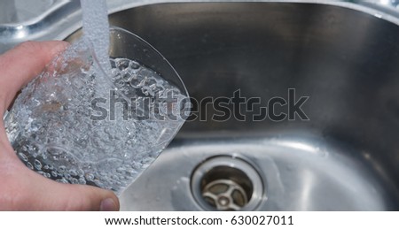 Waterglass in Hand and filling with drink water