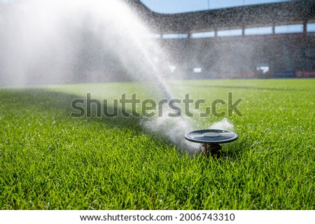 Watering grass on a football stadium