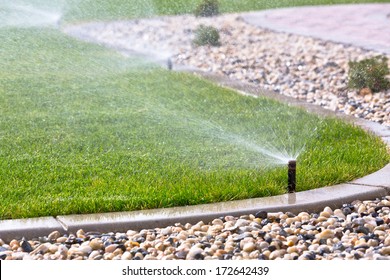 watering lawn with sprinklers