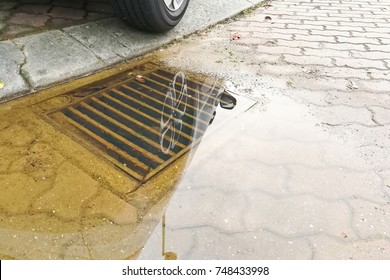 Waterlogged on street after rain due to badly clogged drainage system