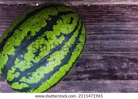 Watermelon composition on a brown wooden board surface background