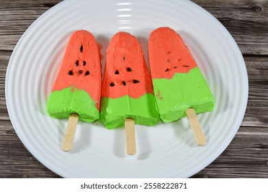 watermelon ice cream bar made of fruit shape and flavor, an ice cream bar is a frozen dessert featuring ice cream on a stick, summertime and holidays concept, selective focus - Powered by Shutterstock