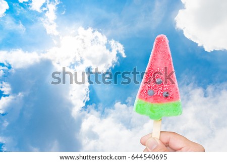 Watermelon ice cream popsicle over sunny blue sky background