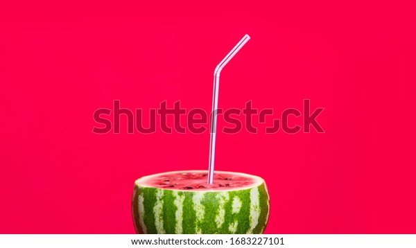 Watermelon juice with a straw concept isolated\
over red background