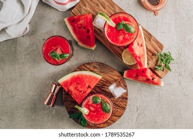 Watermelon Lemonade With Lime And Fresh Basil Leaves On Concrete Background. Refreshing Summer Drink. Top View