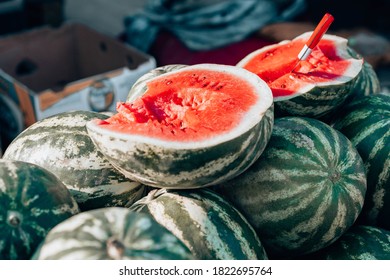 Watermelon market. Many large watermelons and one cut piece of watermelon