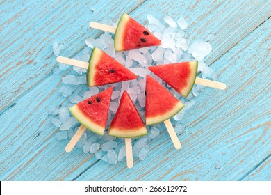 watermelon popsicle yummy fresh summer fruit sweet dessert on vintage old wood teak blue flat lay - Powered by Shutterstock