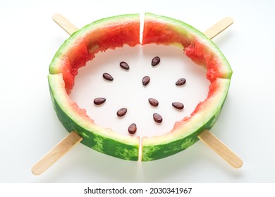 Watermelon rind with wooden sticks and seeds