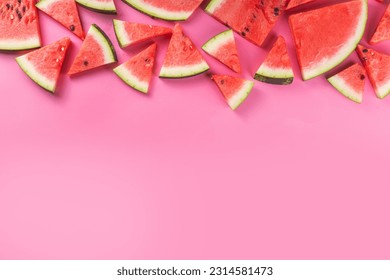 Watermelon slices arranged on high-colored pink background. Simple basic summer harvest and holiday background, top view flat lay banner copy space - Powered by Shutterstock