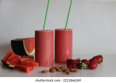 Watermelon Strawberry Smoothie. Summer Drink Made Of Watermelon And Fresh Strawberries In Almond Milk. Shot On White Background Along With Watermelon Slices Cut In Triangle Shape.