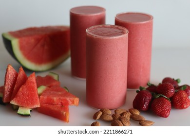 Watermelon Strawberry Smoothie. Summer Drink Made Of Watermelon And Fresh Strawberries In Almond Milk. Shot On White Background Along With Watermelon Slices Cut In Triangle Shape.