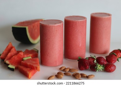 Watermelon Strawberry Smoothie. Summer Drink Made Of Watermelon And Fresh Strawberries In Almond Milk. Shot On White Background Along With Watermelon Slices Cut In Triangle Shape.