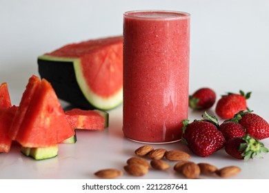 Watermelon Strawberry Smoothie. Summer Drink Made Of Watermelon And Fresh Strawberries In Almond Milk. Shot On White Background Along With Watermelon Slices Cut In Triangle Shape.