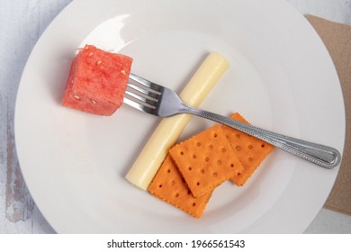 Watermelon, String Cheese And Cheese Crackers On A Plate